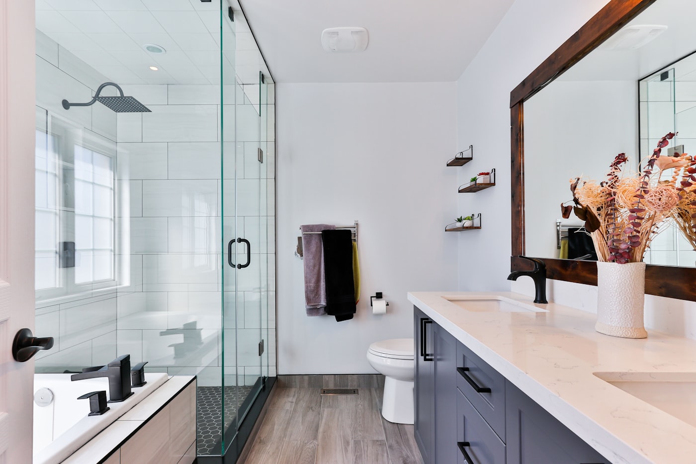 Modern bathroom remodel with glass shower enclosure and matte black fixtures