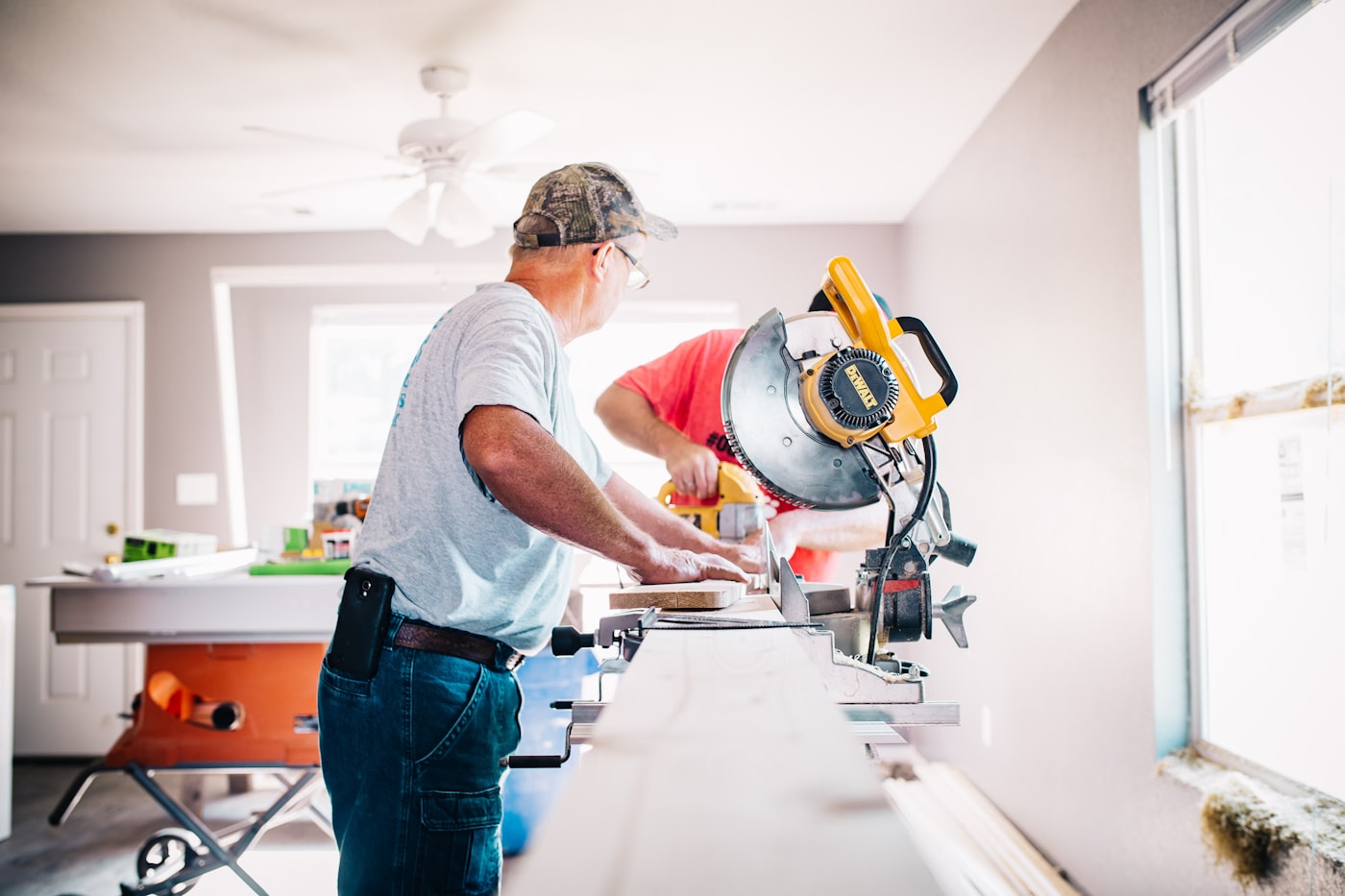Contractors framing and finishing an interior room addition